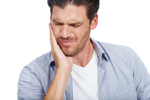 Image of a man holding his broken jaw. Learn about diagnosis and treatment at Dr. Choyee, Oral Surgeon in Whittier, CA.